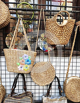 Woven straw summer women\'s bags in the window of street store