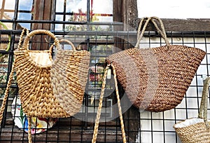 Woven straw summer women\'s bags in the window of street store