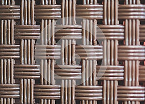 Woven texture of a wicker basket weave, showcasing the intricate patterns and natural charm