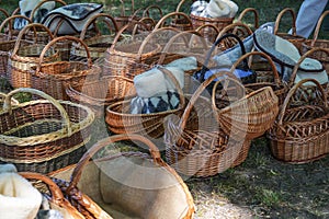 Woven wicker baskets and sheepskin slippers for sale at a historic craft market in Germany, selected focus