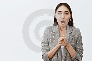 Wow, amazing, tell me more. Portrait of stunned and shocked good-looking asian girlfriend in jacket over t-shirt