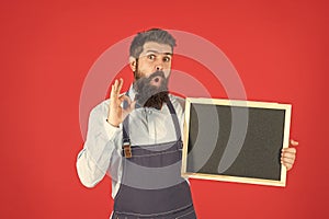 Wow. Bearded man show OK holding blackboard. School enrolment. Chalkboard for enrolment information
