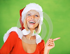 Wow, Christmas and woman in studio pointing to marketing, advertising or branding space with a smile. Green background