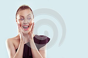 Wow. Closeup portrait young woman beautiful girl with ponytail hair looking excited holding her mouth opened hands on cheeks