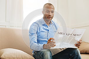 Shocked man reading a newspaper