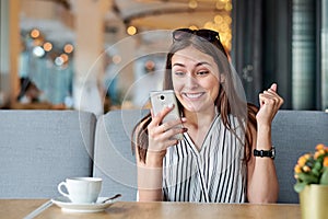 Wow effect, woman enjoying a good message on the phone. Emotions, surprise, delight