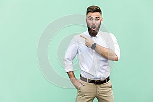 Wow! Handsome young adult man with beard in shoked. photo