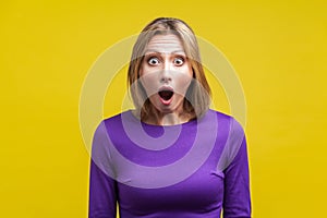 Wow, I can`t believe this! Portrait of astonished woman with stunned shocked face. indoor studio shot isolated on yellow