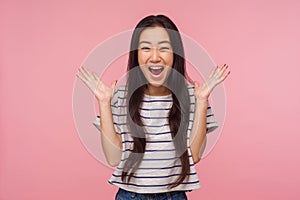 Wow, I won! Portrait of surprised girl with long hair in striped t-shirt screaming in amazement