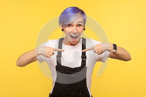 Wow this is me! Portrait of happy and surprised hipster woman pointing herself, looking with amazement at camera. studio shot