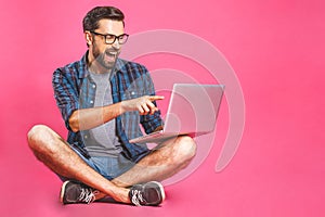Wow! Online working concept. Casual business man relaxed working and browsing internet on laptop computer. Freelance sitting and
