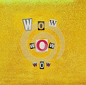 Wow paper cut letters. yellow embossed background