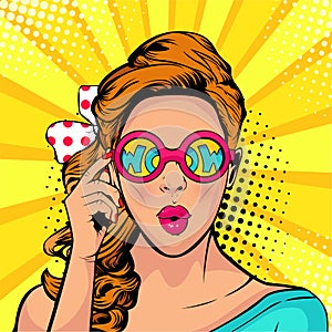 Wow pop art face of surprised woman open mouth holding sunglasses in her hand with inscription wow in reflection. photo