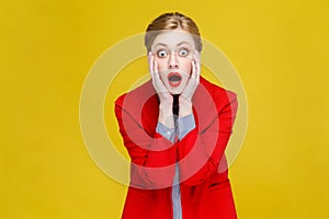 Wow! Red head woman in red suit amazement and open mouth