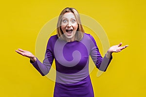 Wow, unbelievable! Portrait of positive astonished woman with widely open mouth and big eyes. isolated on yellow background photo