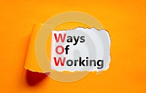 WOW ways of working symbol. Concept words WOW ways of working on white paper on a beautiful orange background. Business and WOW