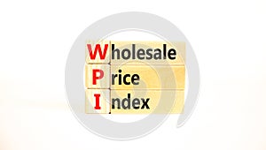 WPI wholesale price index symbol. Concept words WPI wholesale price index on wooden blocks on a beautiful white table white