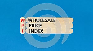 WPI wholesale price index symbol. Concept words WPI wholesale price index on wooden sticks on beautiful blue table blue background