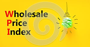 WPI wholesale price index symbol. Concept words WPI wholesale price index on yellow paper on a beautiful yellow background. Light