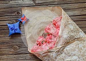 Wrapped bouquet of pink roses with Valentines gift