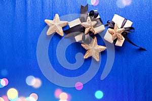 Wrapped boxes with presents and decorative golden stars.