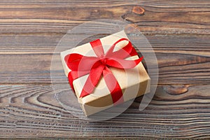 Wrapped christmas or other holiday handmade present in craft paper with colored ribbon. Present box, decoration of gift