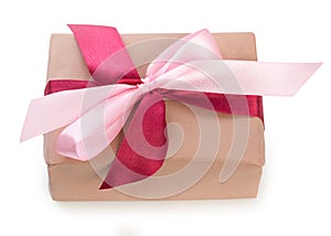 Wrapped gift box with two colors red and pink ribbon bow, isolated on a white background, close up, top view