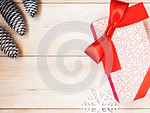 Wrapped gift box on the wooden board. Christmas and New year concept