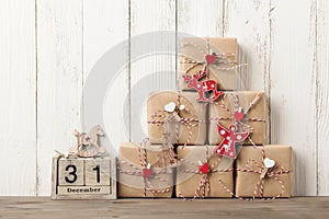 Wrapped gift boxes with christmas decorations on wooden table