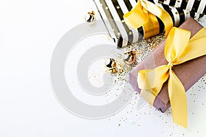 Wrapped gifts in black and white,purple paper,golden ribbon on white background.Preparation for celebrate concept