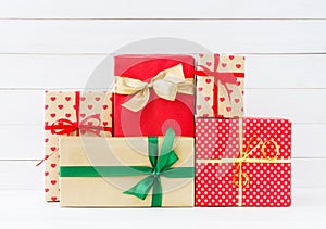 Wrapped gifts boxes on white wooden background. Copy space
