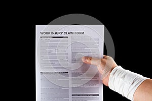 Wrapped hand holding work injury claim form