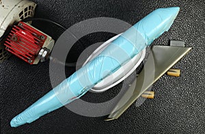 The wrapped plastic model plane put beside air compressor unit