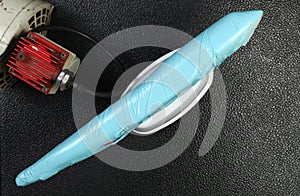 The wrapped plastic model plane put beside air compressor unit