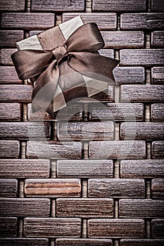 Wrapped present box on wooden wicker place mat