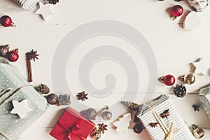 Wrapped present boxes with ornaments with cones anise on white w