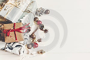 Wrapped present boxes with ornaments pine cones anise and lights