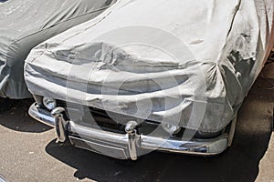 A wrapped up car in the street in summer