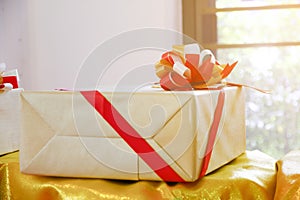 Wrapped vintage gift box with red ribbon bow, photo