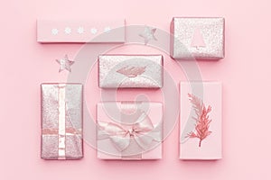 Wrapped xmas boxes. Gift wrapping. Pink nordic christmas gifts isolated on pastel pink background.
