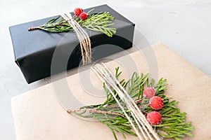 Wrapping Christmas gifts in recycled paper in rustic style. Xmas Gift boxes with craft paper