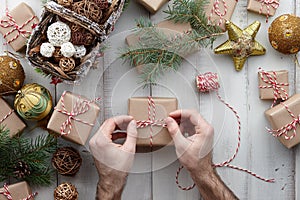 Wrapping Christmas presents and gift boxes in kraft paper