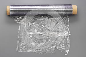 Wrapping plastic stretch film roll, abstract plastic waste concept. Copy space