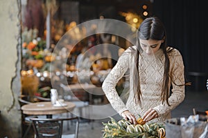 Wrapping up the creation of the Christmas wreath at the flower shop& x27;s display.