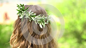 A wreath of blooming myrtle on the bride`s head