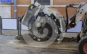 wreath with cones for drilling rock mounted on mini excavator