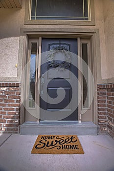 Wreath and doormat on the front door with sidelights and transom window