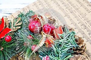 Wreath fir cones, sheet music Christmas songs concept of preparing for the holidays, turquoise shabby wooden table background.