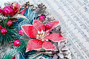 Wreath fir cones, sheet music Christmas songs concept of preparing for the holidays, turquoise shabby wooden table background.