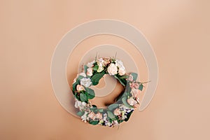 Wreath of flowers on a beige paper background